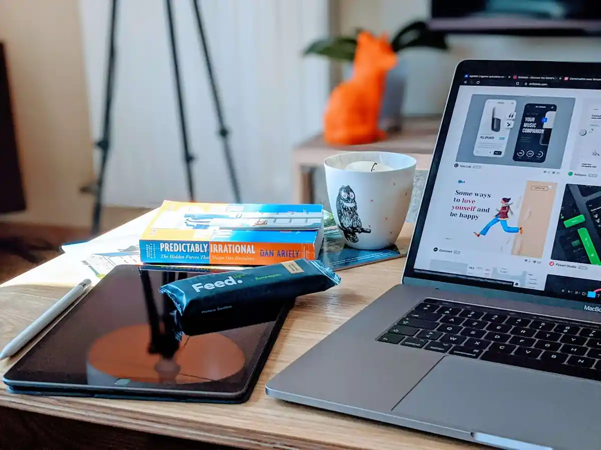 An online store product page open on a laptop beside a phone