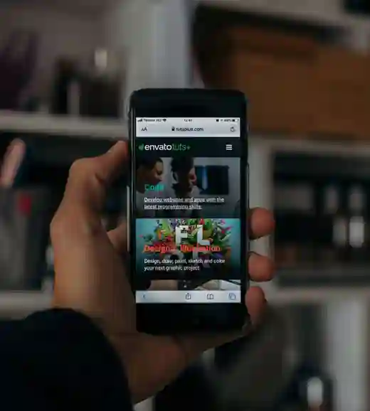 A hand holding a phone showing a mobile website