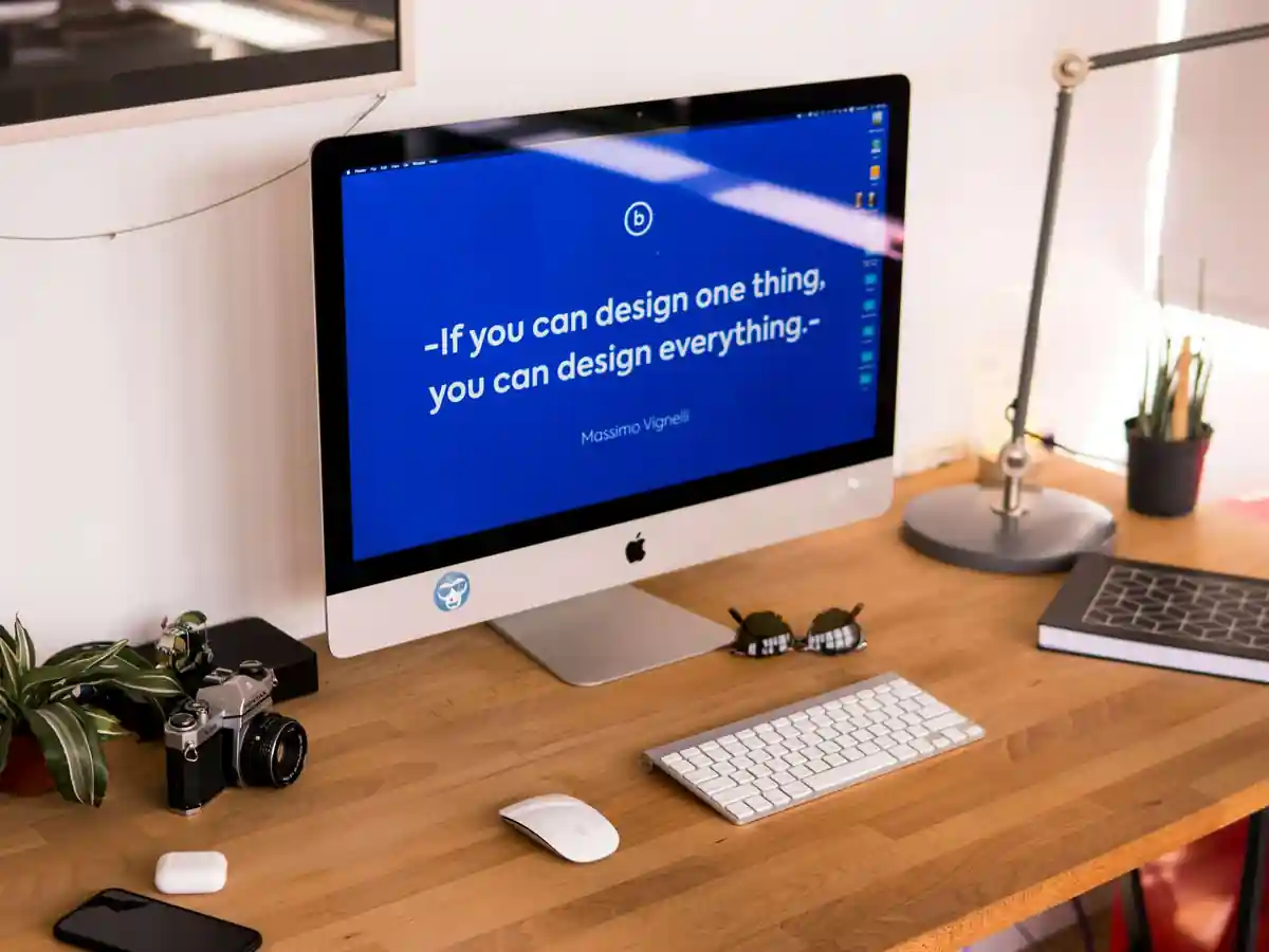 A desktop screen showing a finished website design on a studio desk
